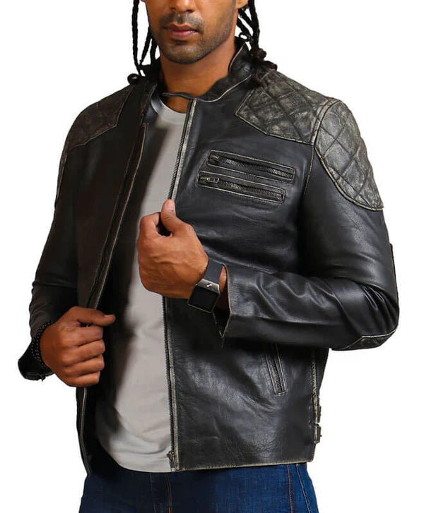 Man wearing a black leather jacket with gray quilted accents on a white background