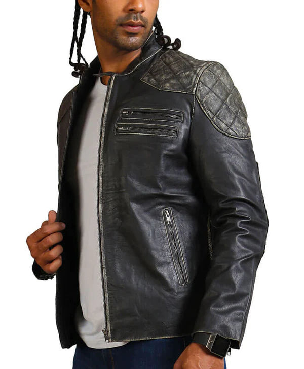 Black leather jacket with quilted shoulder design worn by a person on a white background